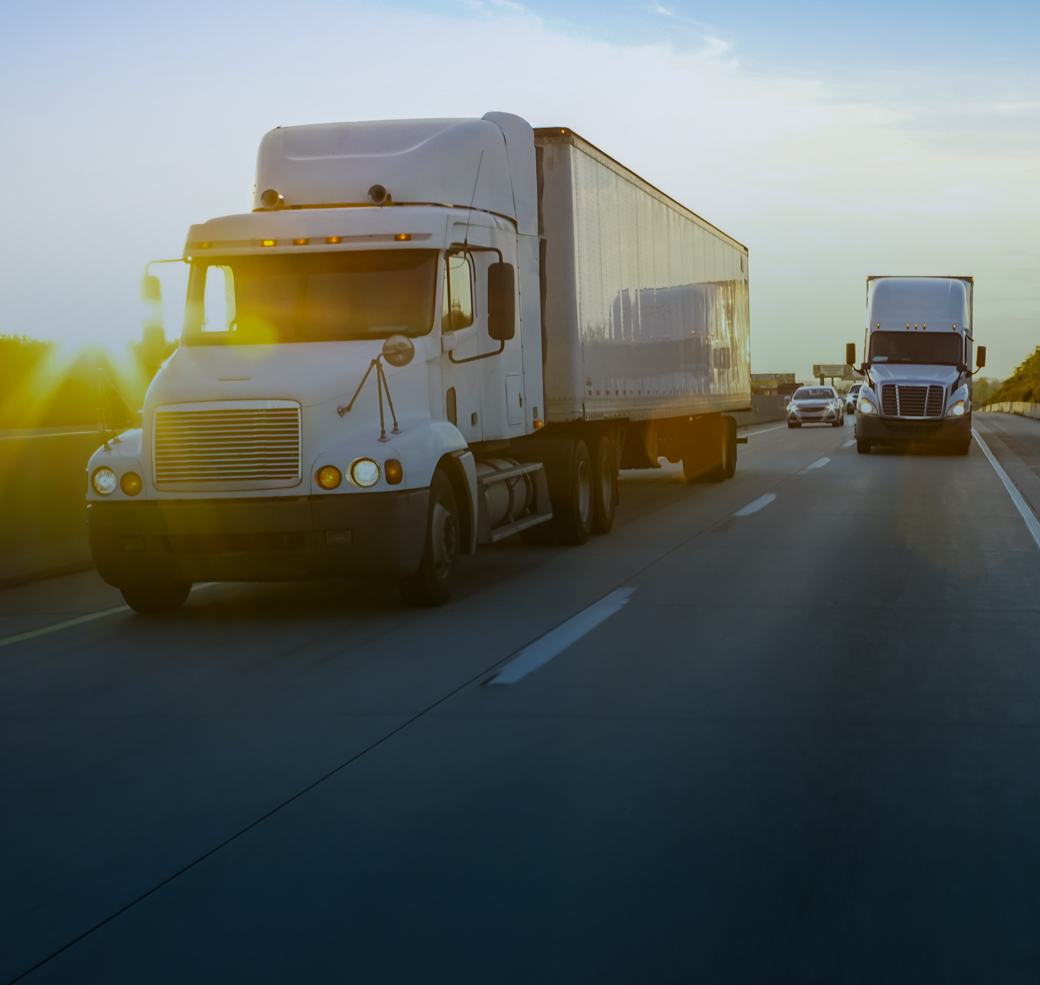 Semi tractor trailer driving on the highway in the evening