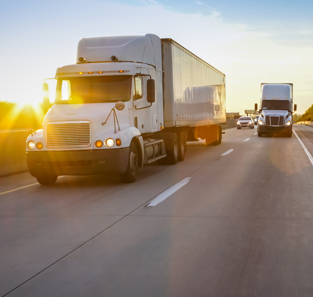 Semi tractor trailer driving on the highway in the evening