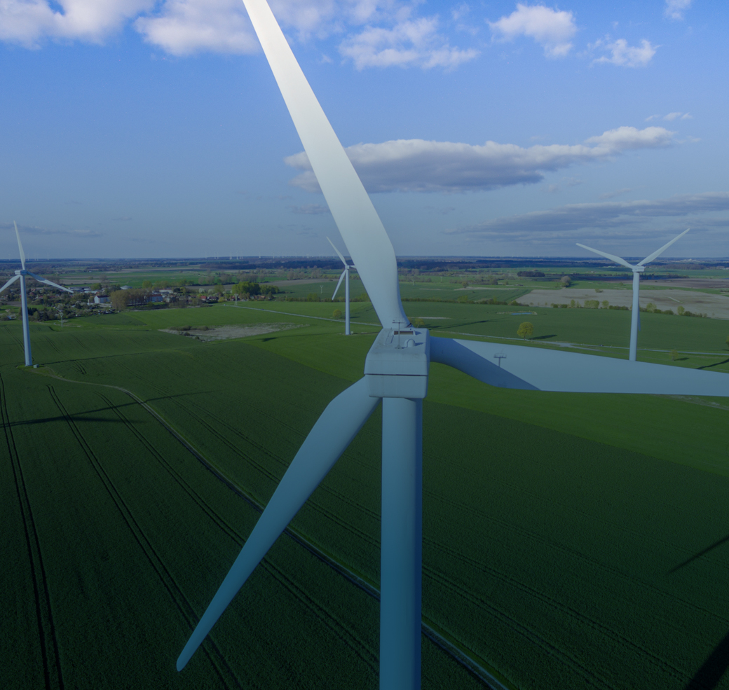 Aerial view of wind turbines in a field.