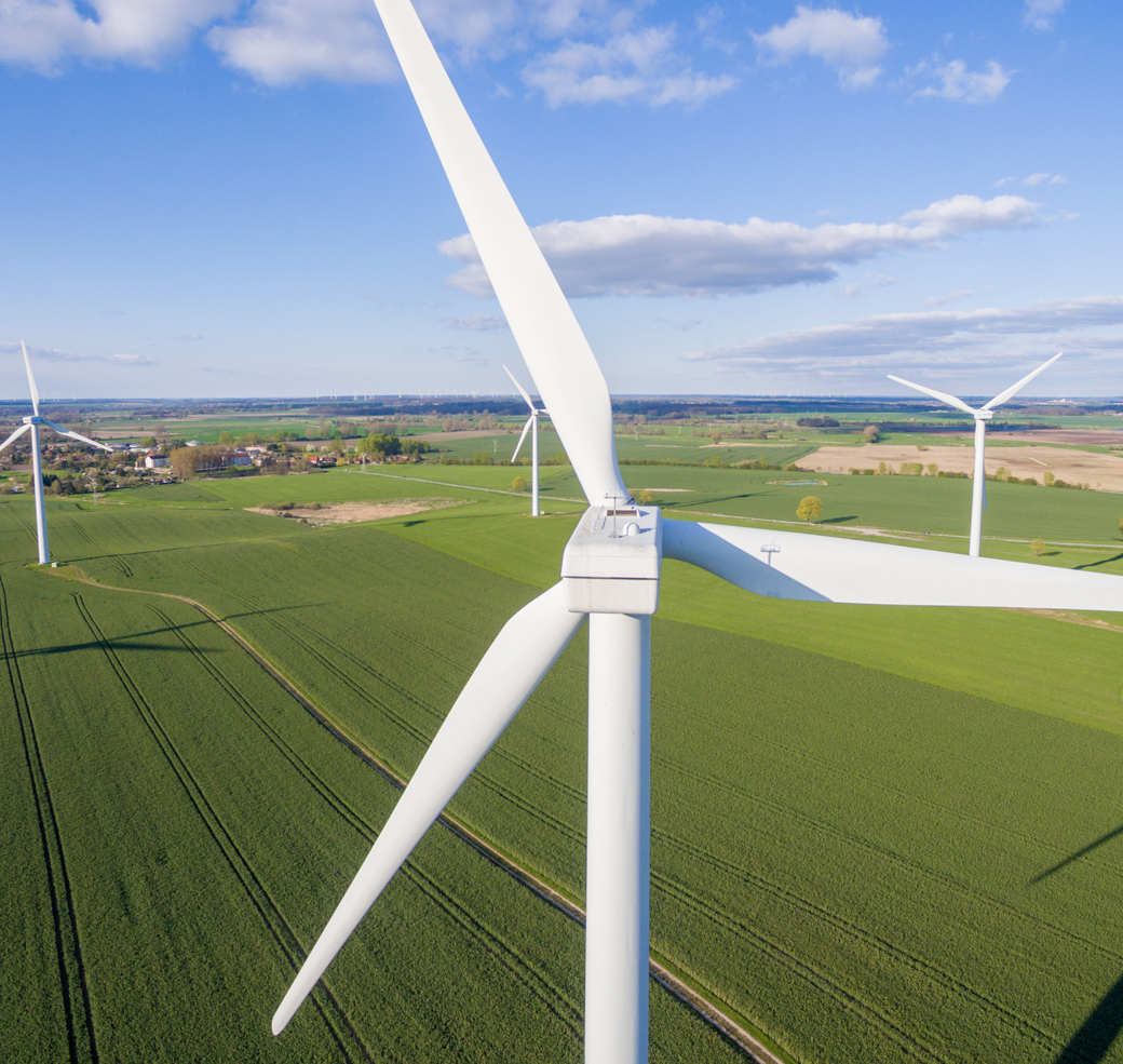 Aerial view of wind turbines in a field.