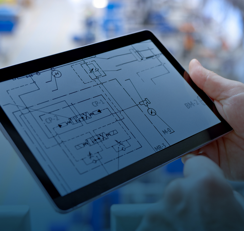 Close-up of hand holding digital tablet displaying technical drawing.
