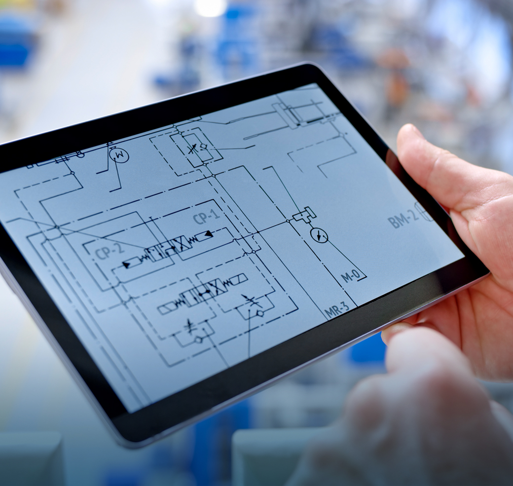 Close-up of hand holding digital tablet displaying technical drawing.